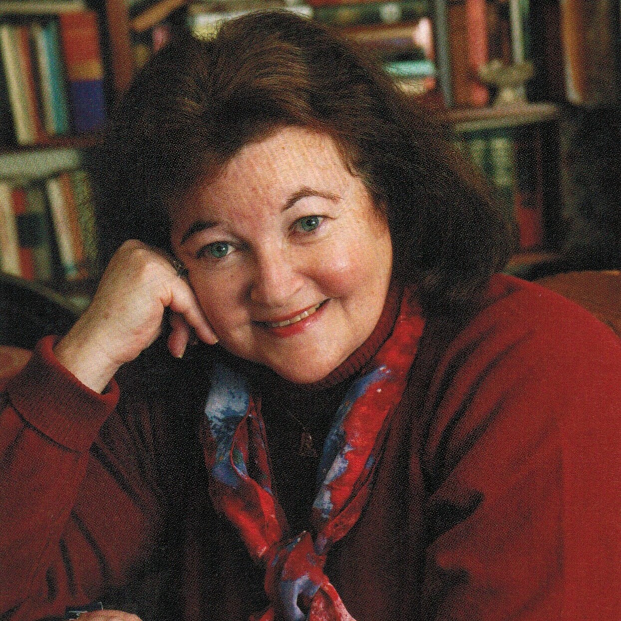 Sharon Sobel headshot wearing a red sweater and matching scarf