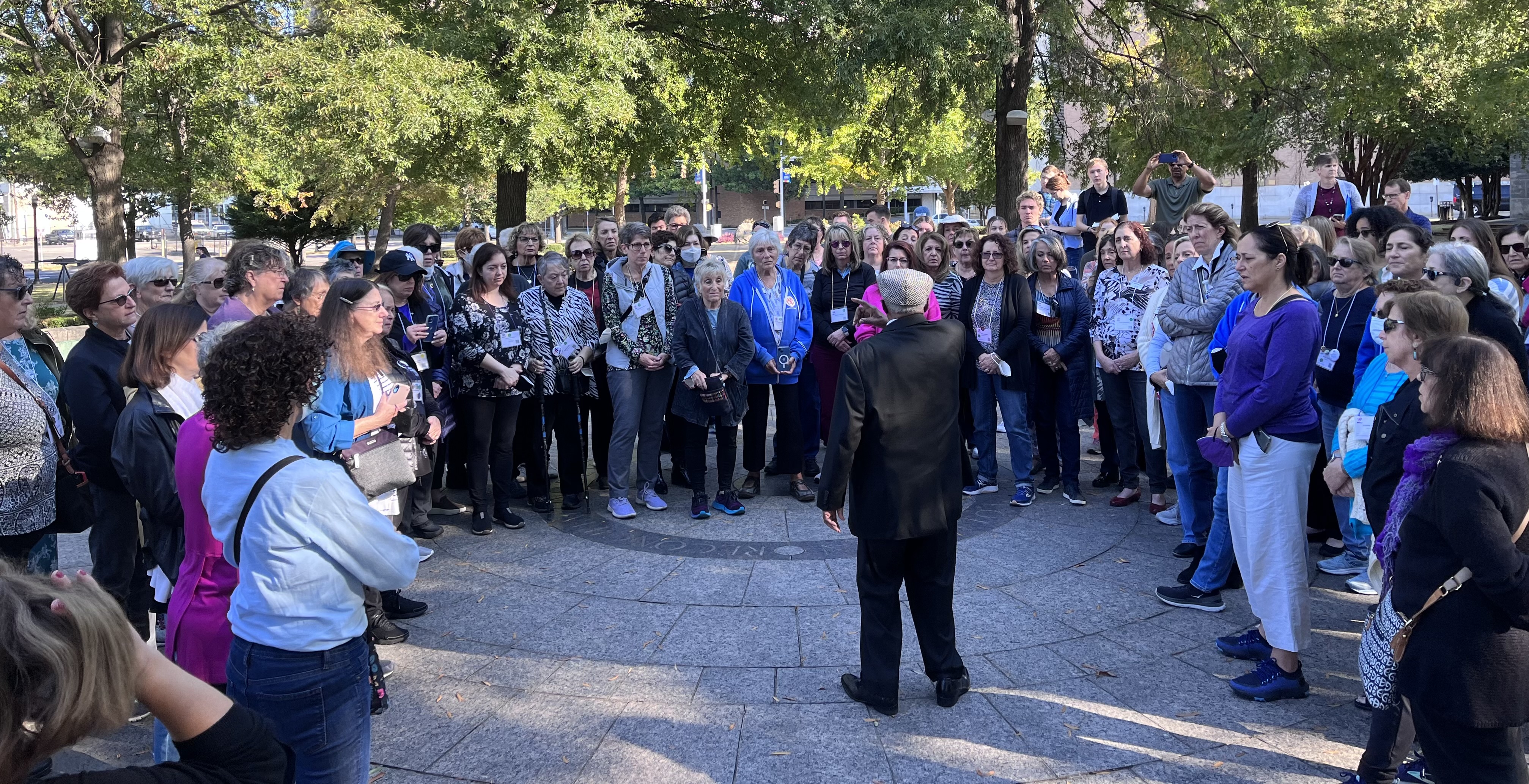 Group shot of WRJ with Bishop Calvin Woods speaking in a park