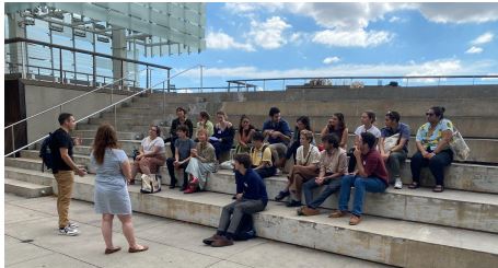 A group of Avodah members on steps facing two people. 