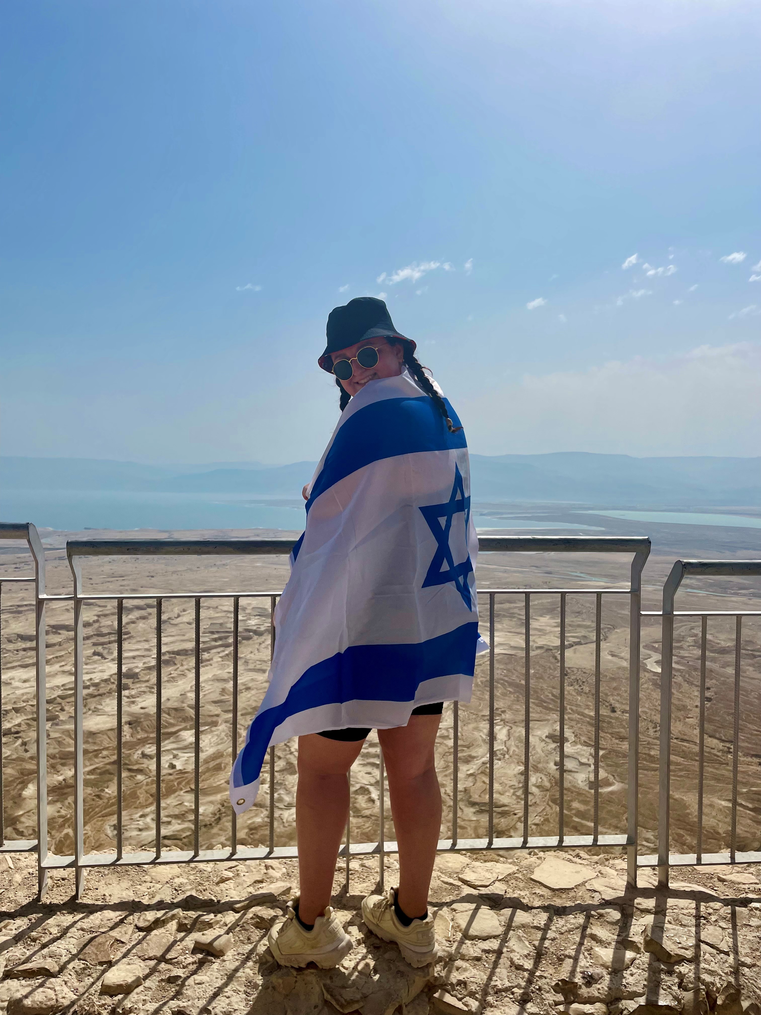 Rachel at Masada wrapping herself in the Israeli flag