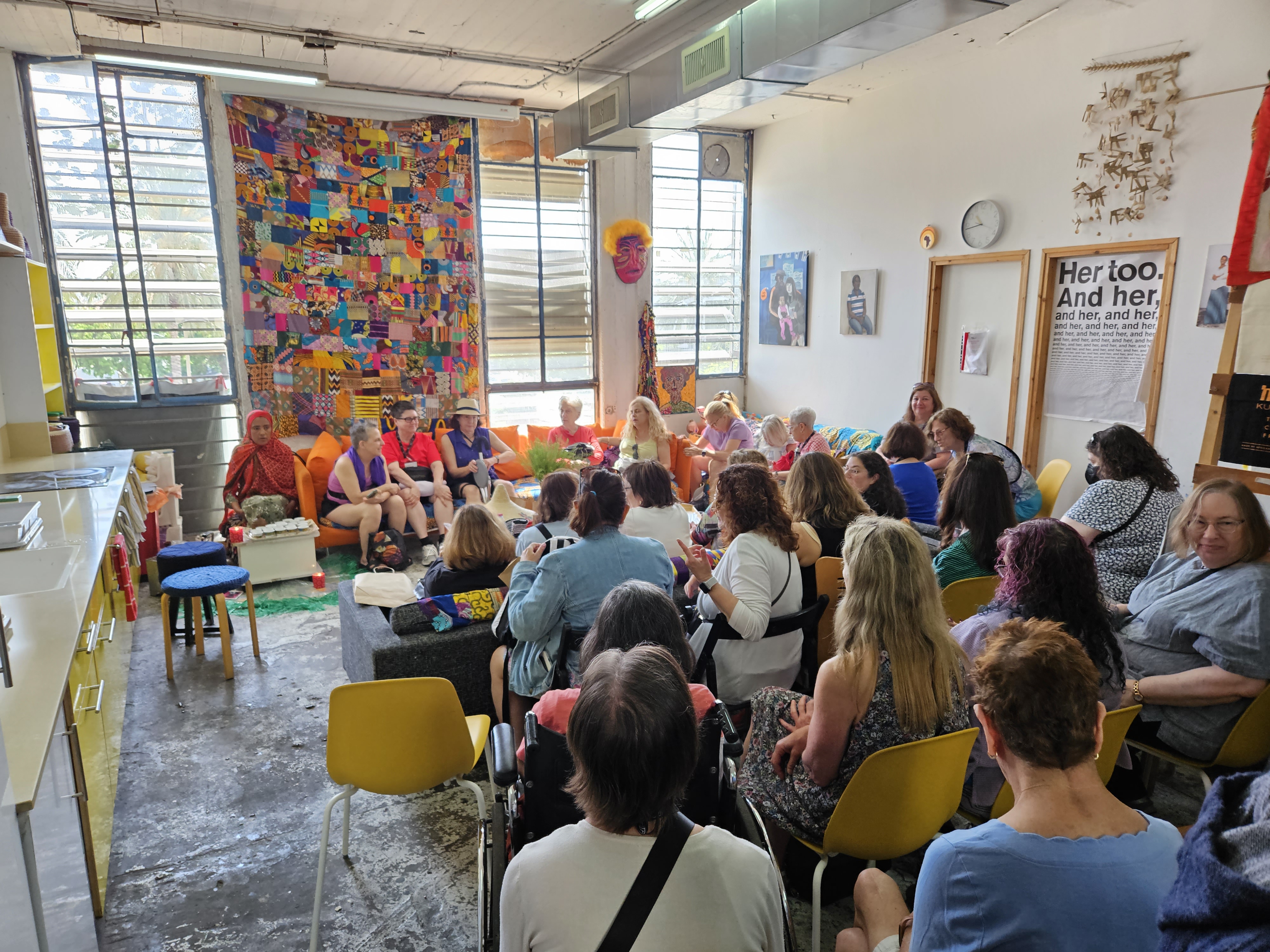 Women learning about Kuchinate, an Israeli business that sells crocheted items to support the African asylum-seeking community and supports