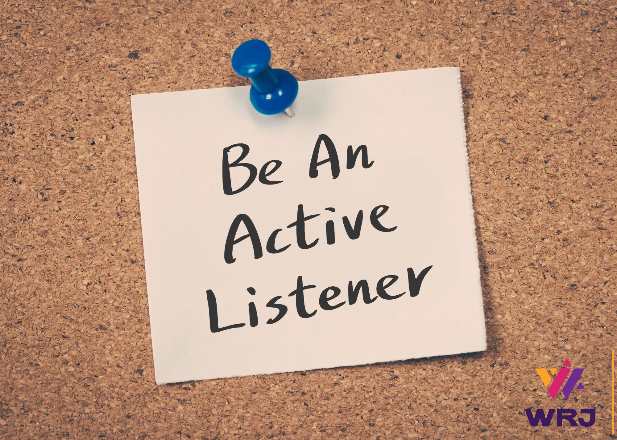 A sticky note that says be an active listening, pinned on a corkboard with a blue thumbtack. 