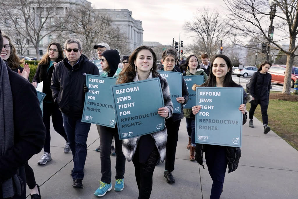 Group of women holding signs