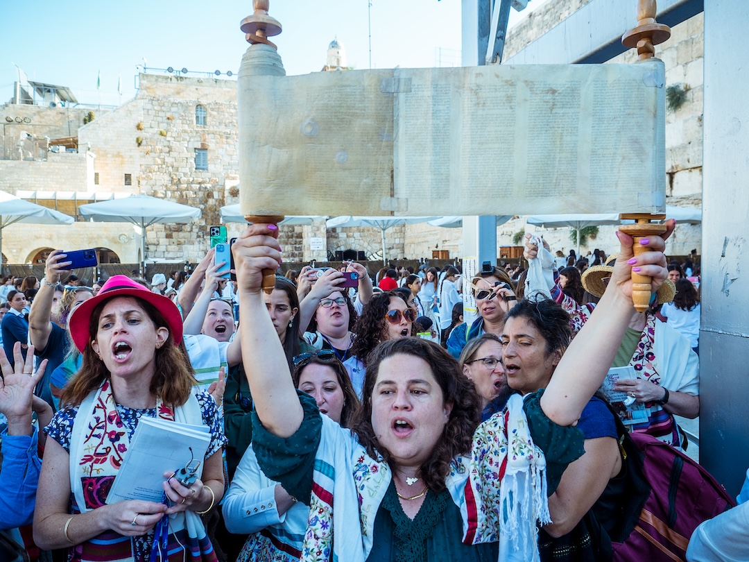 women holding Torah scroll at Women of the Wall event in Israel