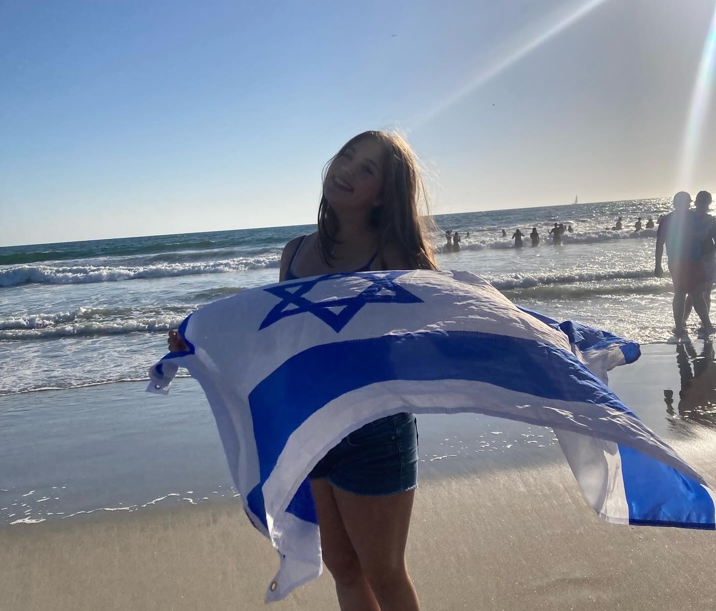 Hayley Nachshon with Israeli flag at the beach