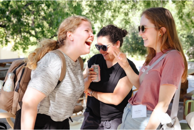 three women laughing together
