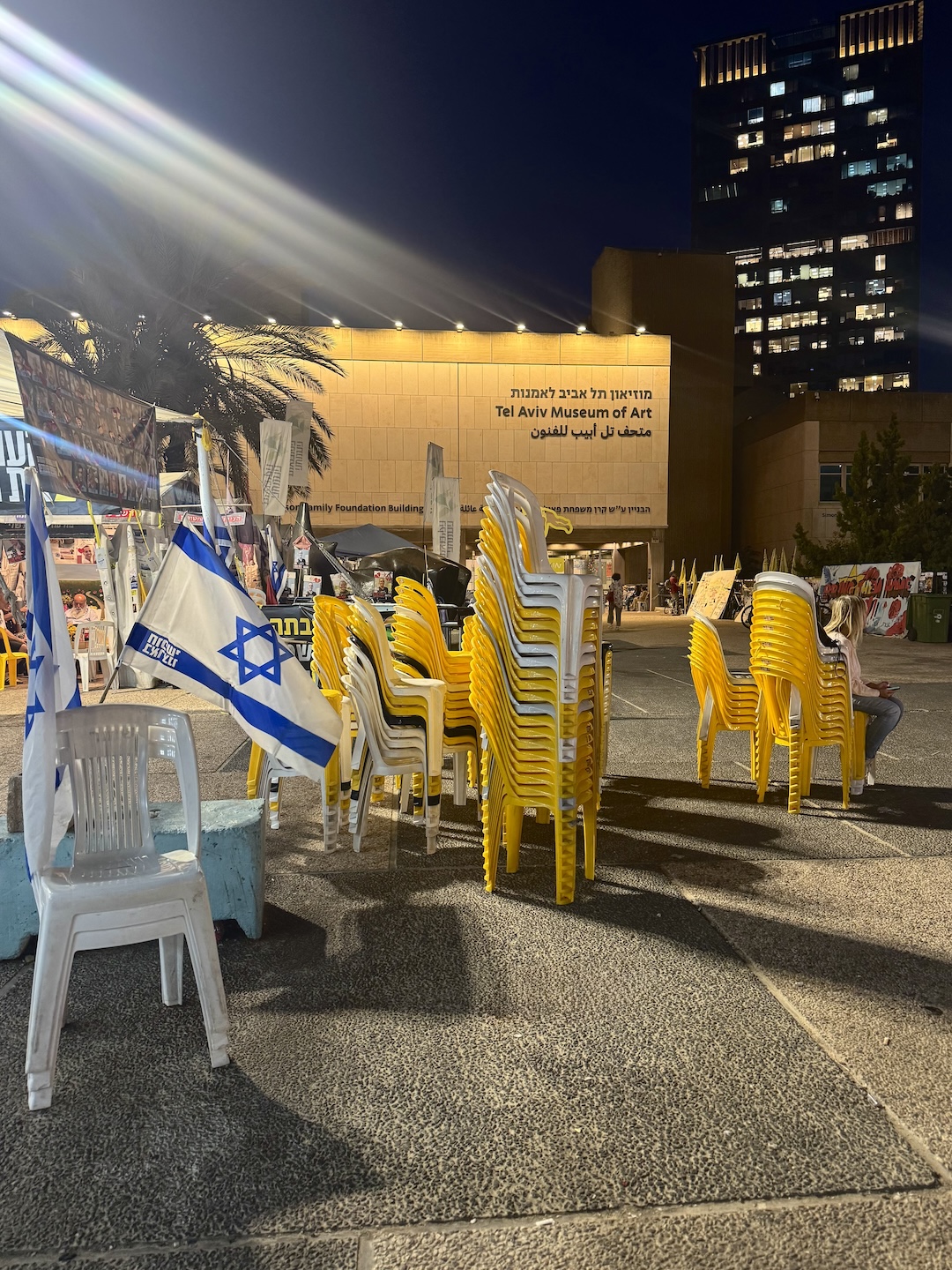 yellow chairs, previously representing missing hostages, stacked neatly