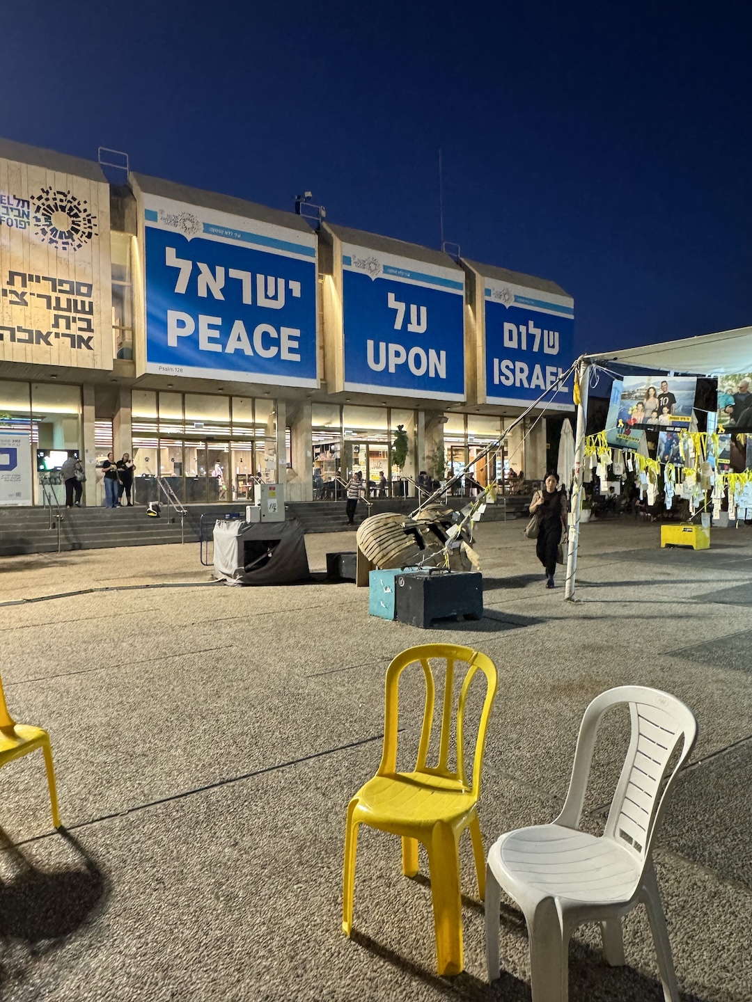 signs reading "Peace Upon Israel" in Hostage Square in Tel Aviv