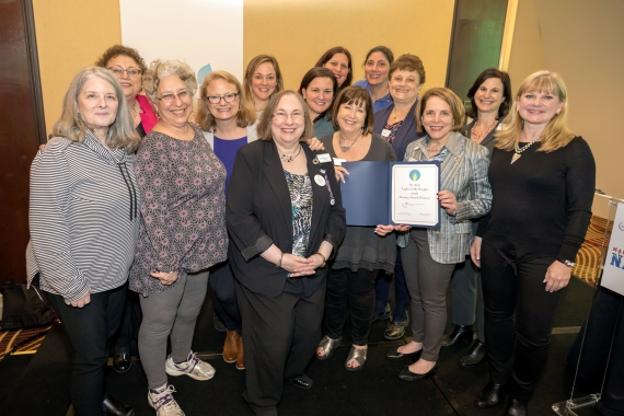 Women being awarded a certificate