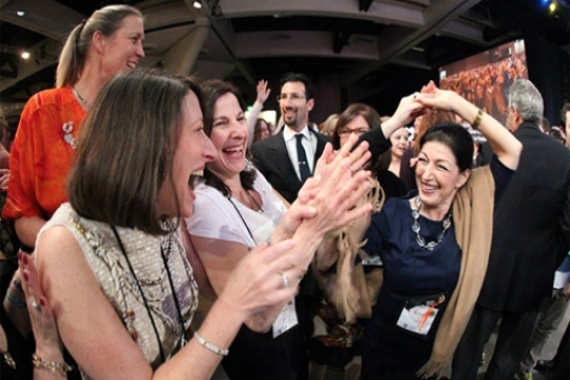 Photo of several women laughing and clapping