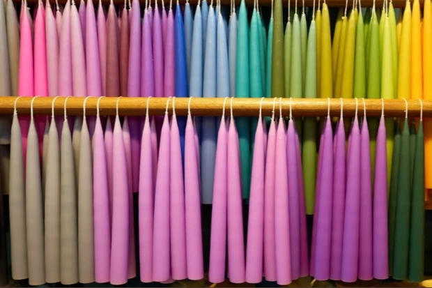 A photo of two rows of colorful long candles