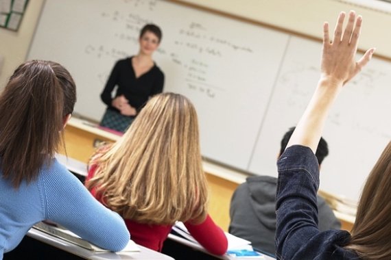 Student raising hand in classroom