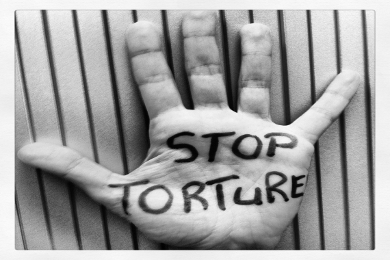 Hand with words "Stop Torture" written on palm