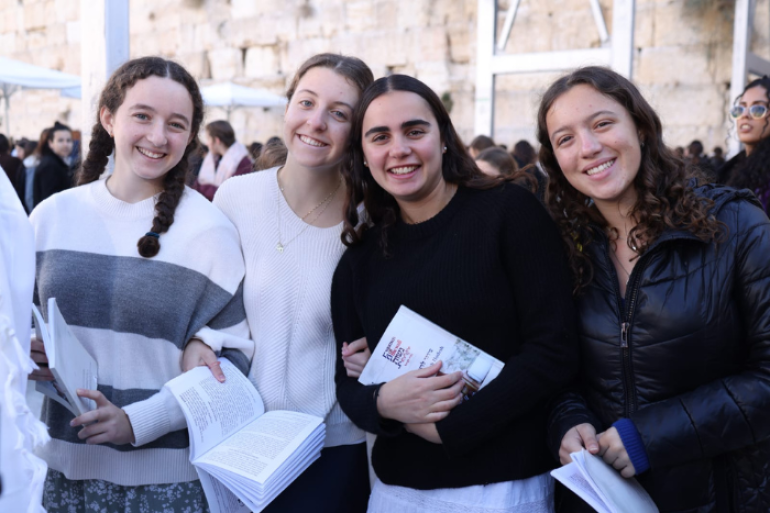 four young women smiling at a Women of the Wall event at the kotel in Jerusalem
