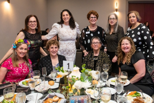 group of eight women posing together for a photo