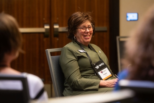 image of Andrea Stillman wearing green sweater smiling