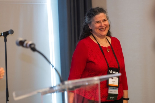 photo of Debra Goetz wearing red long sleeve shirt and smiling