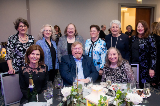 Pamela Feldman-Hill and others, including Executive Director Emerita and Pamela's sister, Rabbi Marla J. Feldman, sitting at table