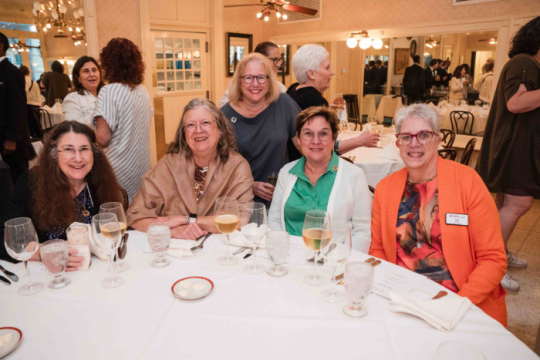women sitting together around a table