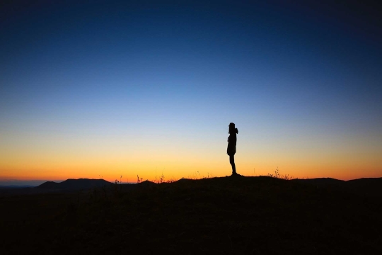 Silhouette on a mountain at sunset