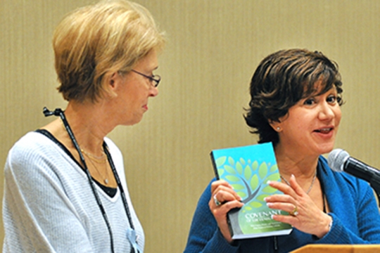 Women holding up book