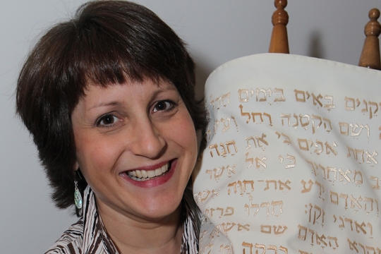 Woman holding up the torah